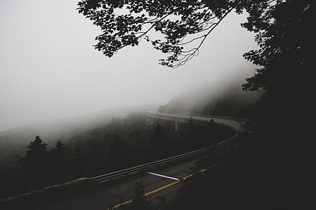 landscape photography of foggy mountain with roads thumbnail
