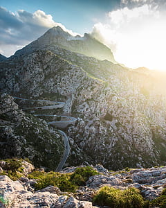 gray asphalt road on white rocky mountain thumbnail