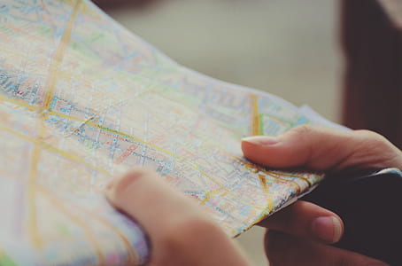 person holding map thumbnail