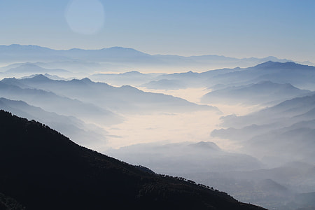silhouette high-angle photography of valley surrounded by mountain ranges view from top of mountain during daytime thumbnail