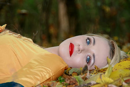 selective focus photography of woman lying in forest thumbnail