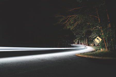 timelapse photography of vehicle in dark road thumbnail
