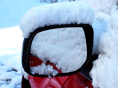 close-up photo of black vehicle side mirror covered with snow thumbnail