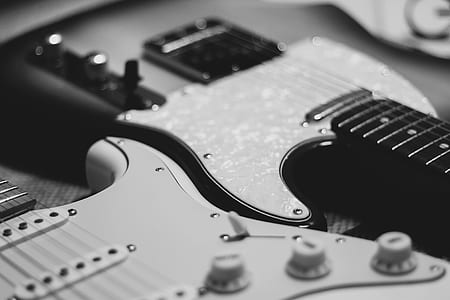 selective focus grayscale photography of two electric guitars thumbnail
