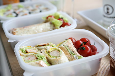 two white plastic containers with sandwich and tomatoes thumbnail