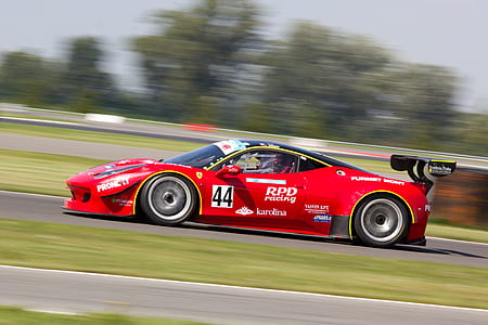 Red Racing Car on Race Track during Daytime thumbnail