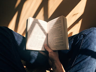 person holding unfold book thumbnail