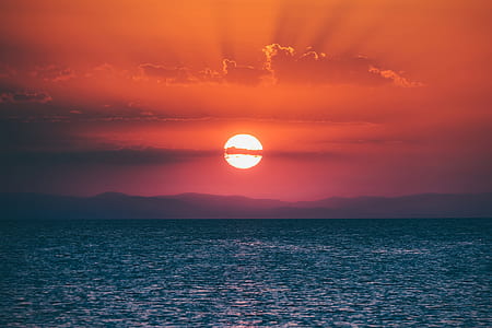 body of water under sun rise thumbnail