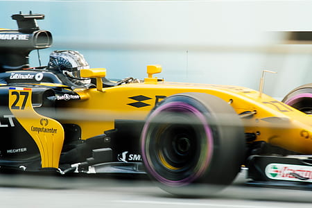 man driving a yellow F1 car thumbnail