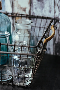 Collection of bottles in metal mesh basket thumbnail