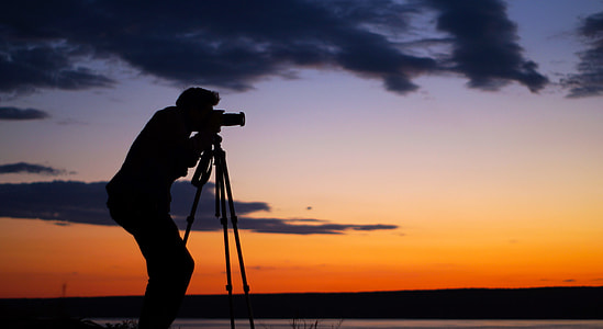 slihouette photo of man using telescope during sunset thumbnail