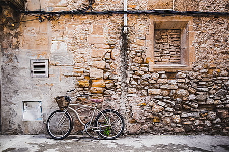 bicycle parked beside concrete house thumbnail