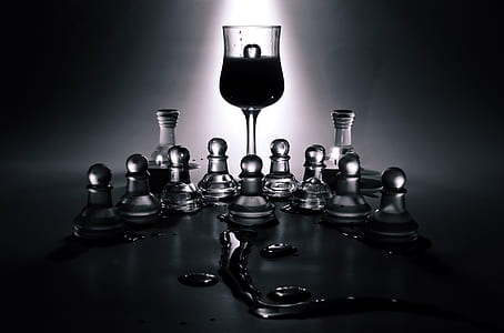 clear wine glass beside chess piece thumbnail