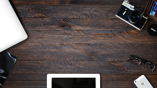 black and gray point-and-shoot camera on brown surface thumbnail