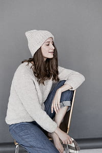 Woman in White Sweater and Beanie With Blue Denim Pants thumbnail