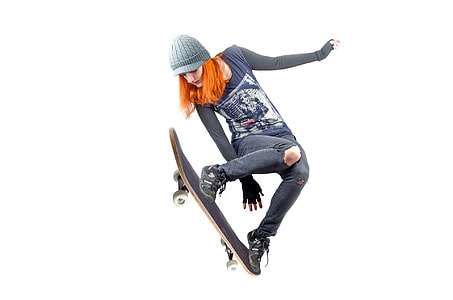 woman in black long sleeve shirt ,pants and pair of shoes  jumping with skateboard on feet thumbnail