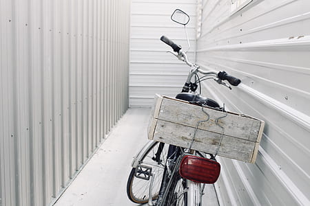 white and black leaning bicycle in gray metalwall thumbnail