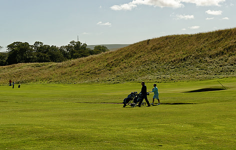 man in black shirt holding golf bag thumbnail