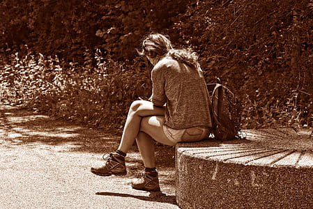 person sitting near trees thumbnail