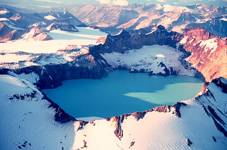 brown mountains covered of snow during daytime thumbnail