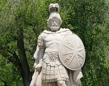 man holding shield statuette thumbnail