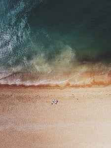 aerial photo of person standing on shore during daytime thumbnail