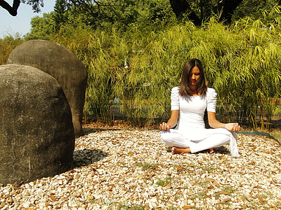 woman meditating surrounded with green trees thumbnail