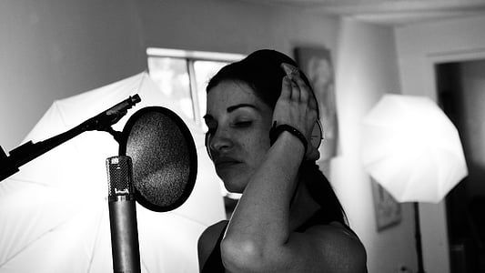 woman standing in front of pop filter thumbnail