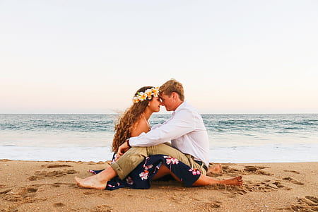 man and woman sitting on seashort thumbnail