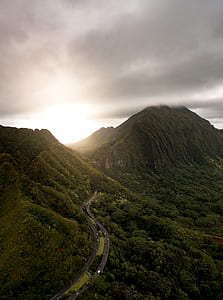 aerial photography of green mountain under grey clouds thumbnail