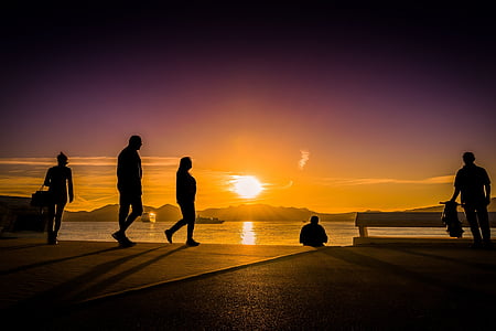 silhouette of person walking near body of water thumbnail