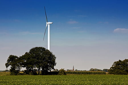white wind turbine beside tree during daytime thumbnail