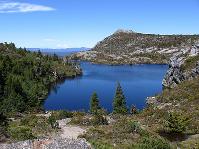 body of water surrounded by mountain thumbnail