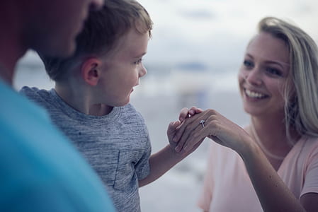 woman holding baby's left hand thumbnail