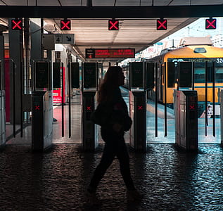 silhouette photography of woman walking at subway thumbnail