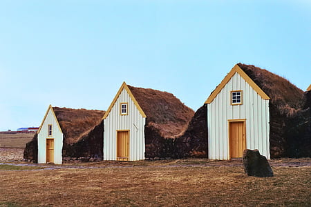landscape photo of three white wooden sheds thumbnail