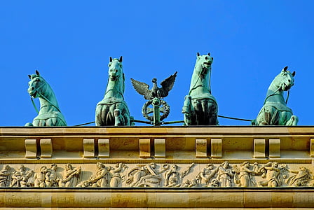 four gray concrete horse statues on roof thumbnail