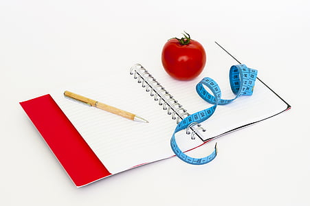 brown pen on white notebook with blue measuring tape thumbnail