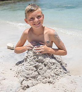 boy sitting on sand thumbnail