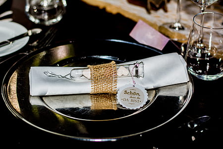 round silver plate beside wine glass thumbnail