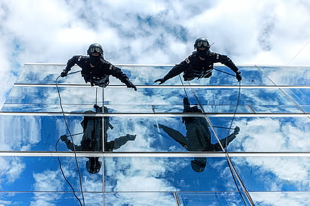 two men hanging beside building thumbnail