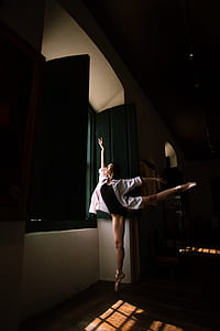 woman dancing ballet inside the room at night thumbnail