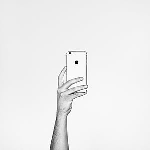 grayscale photography of person holding iPhone thumbnail