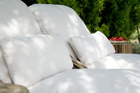 two white beds near tall trees and table with vegetable at daytime thumbnail