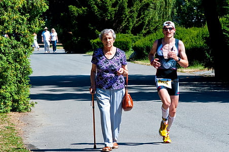 man in black tank top running beside woman thumbnail