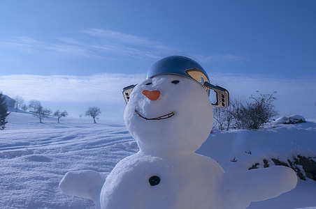 shallow focus photography of snowman wearing blue cooking pot thumbnail