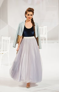 brown haired woman wearing blue formal coat and blue and gray dress thumbnail