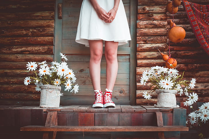 woman wearing white dress and red sneakers