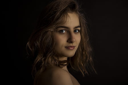smiling woman facing side way on dim lighted room thumbnail