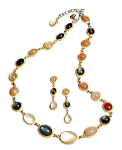 gold-colored necklace and earrings with gemstones thumbnail